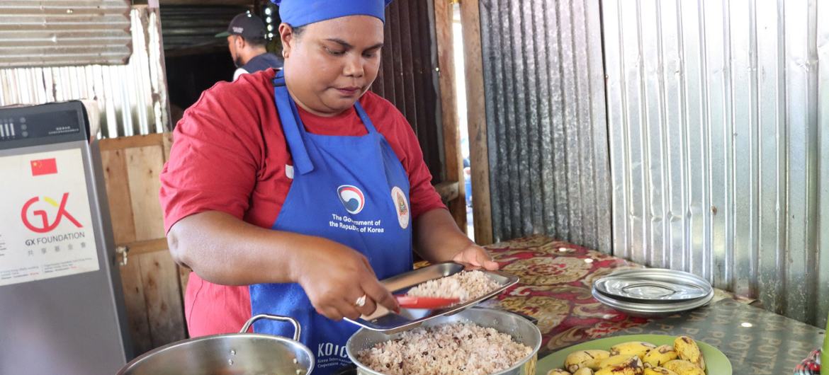 Uma cozinheira escolar em Timor-Leste prepara comida com ingredientes locais.