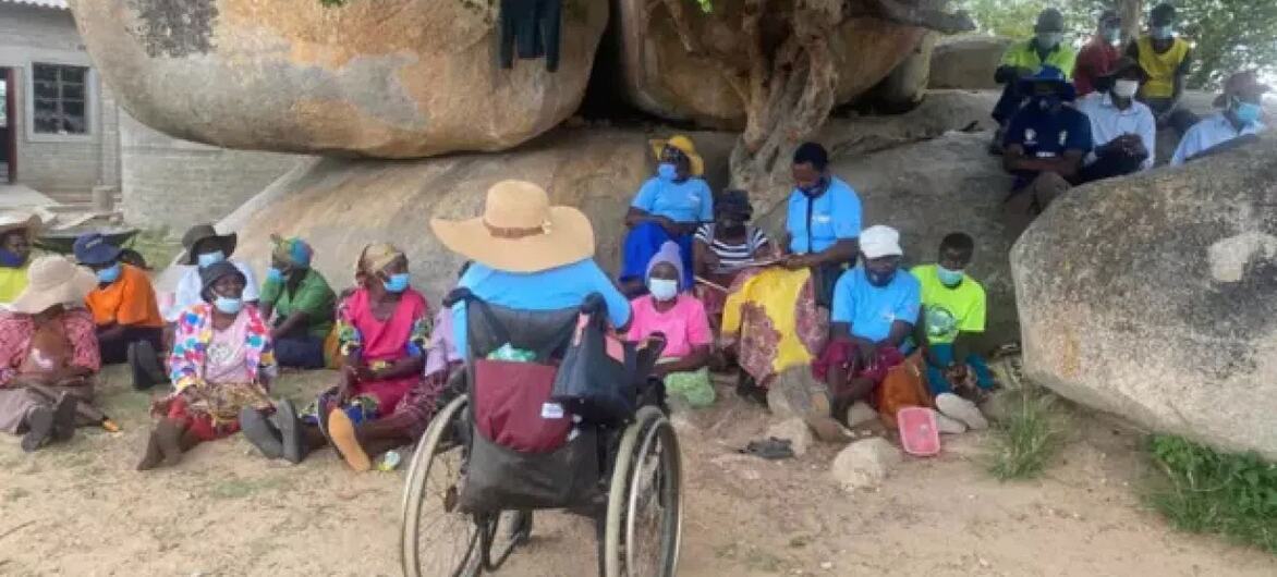 Ndakaitei Matare, uma mulher rural com deficiência física no Zimbabué, preside uma reunião comunitária com outras mulheres que defendem os direitos das pessoas com deficiência e o acesso a recursos.