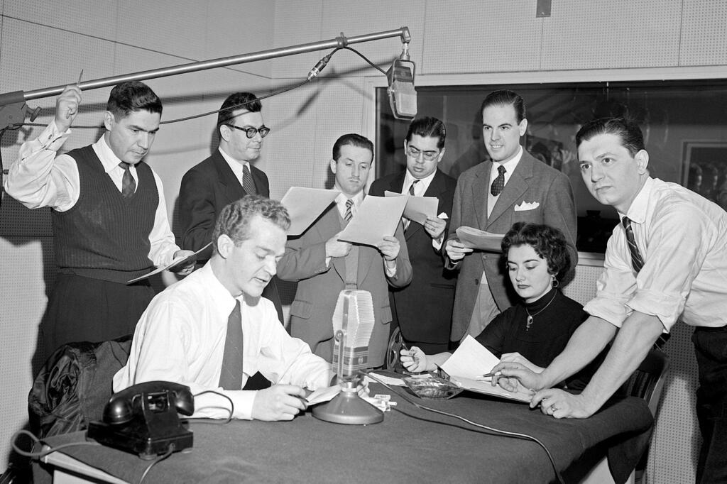 From left to right:  José Quijano-Santos; Luis Marron; Hernando Solano; Jorge A. Carvallo, Luis Carlos Sanchez, Osvaldo Lopez Noguerol; Beatrix Alcapra Cuellar; and Guillermo Caram, members of the staff of the UN Radio Division are recording a special broadcast for the radio networks of the Latin American countries, at UN Headquarters in New York.